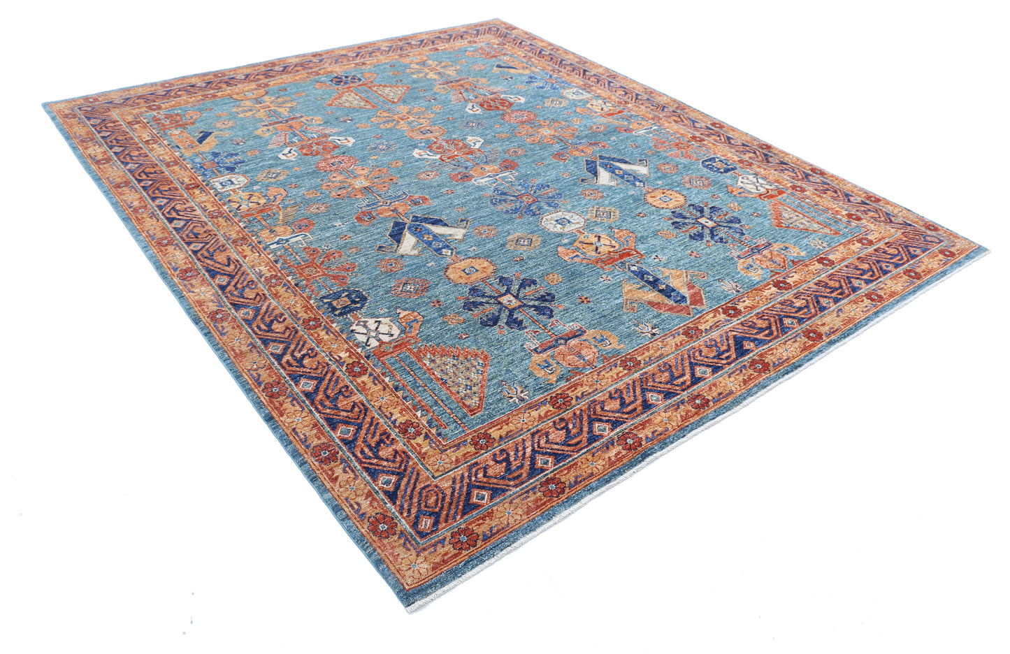 New Tribal Humna hand-knotted wool rug 8'1" x 9'5" (246 x 287 cm) in green, from Artemis Rugs in Carmel, CA. Authentic handmade Humna wool rug featuring bold tribal patterns and intricate geometric motifs. Crafted with high-quality, durable wool fibers using expert hand-knotting techniques. This green Humna rug offers rich texture and genuine artisan craftsmanship, ideal for collectors and enthusiasts of authentic handmade tribal wool rugs