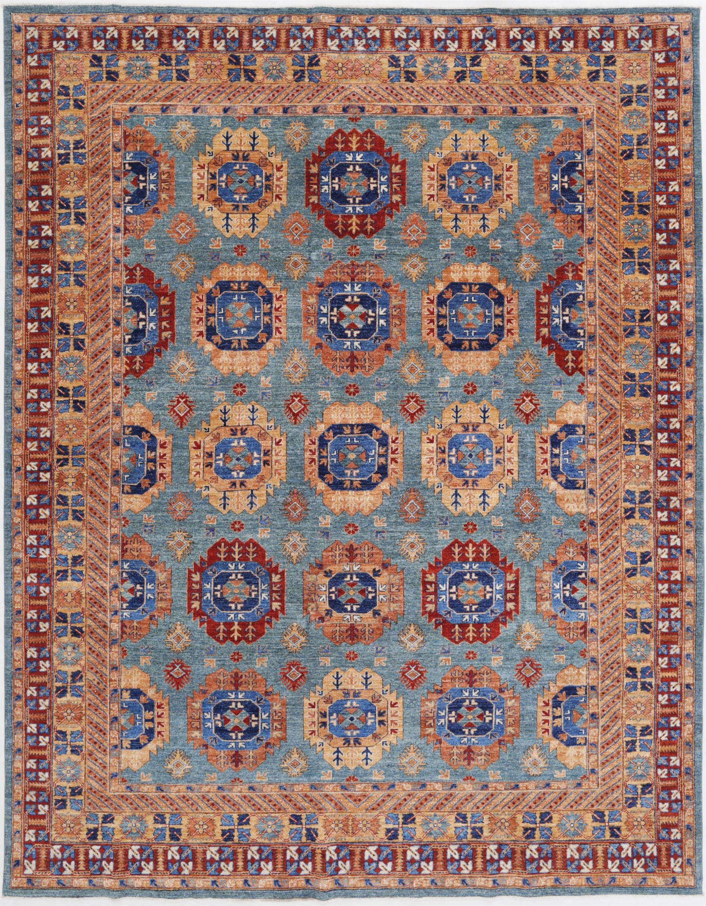 New Tribal Humna hand-knotted wool rug 9'1" x 11'10" (277 x 361 cm) in green, from Artemis Rugs in Carmel, CA. Authentic handmade Humna wool rug featuring bold tribal patterns and intricate geometric motifs. Crafted with high-quality, durable wool fibers using expert hand-knotting techniques. This green Humna rug offers rich texture and genuine artisan craftsmanship, perfect for collectors and enthusiasts of authentic handmade tribal wool rugs