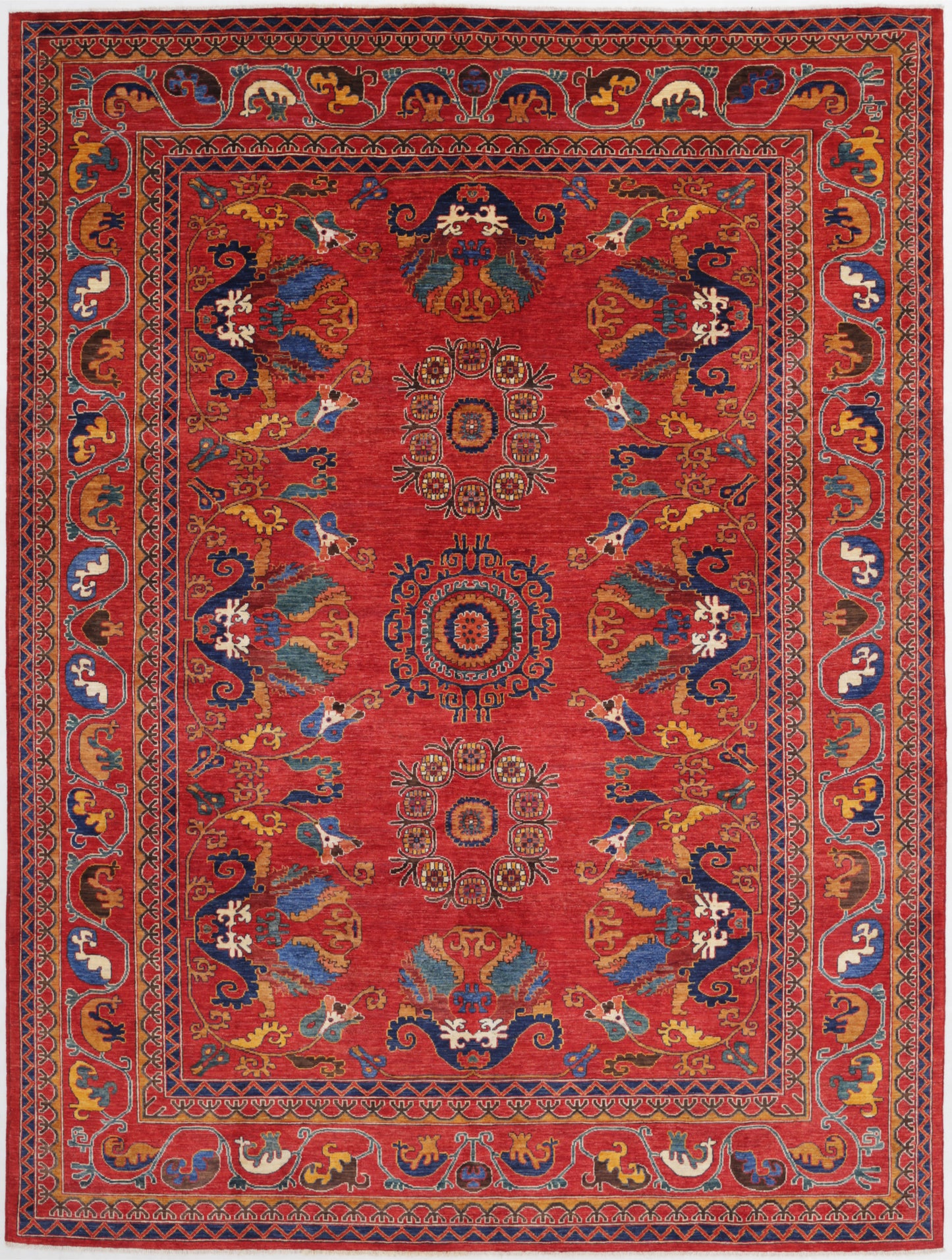 New Tribal Humna hand-knotted wool rug 9'1" x 12'0" (277 x 366 cm) in red, from Artemis Rugs in Carmel, CA. Authentic handmade Humna wool rug featuring bold tribal patterns and intricate geometric motifs. Crafted with high-quality, durable wool fibers using expert hand-knotting techniques. This vibrant red Humna rug offers rich texture and genuine artisan craftsmanship, perfect for collectors and enthusiasts of authentic handmade tribal wool rugs.