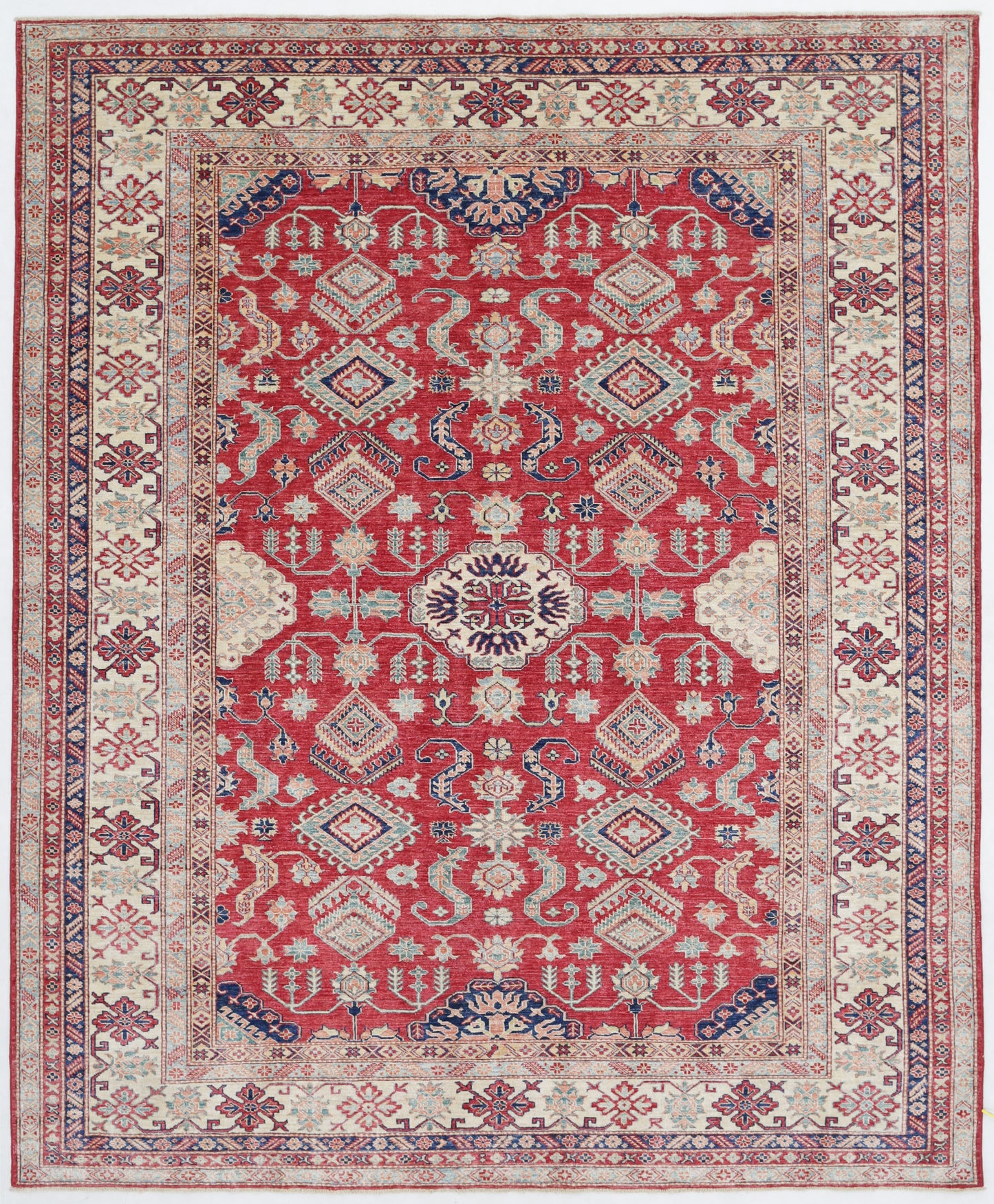 New Tribal Kazak hand-knotted wool rug 7'11" x 9'8" (241 x 295 cm) in red, from Artemis Rugs in Carmel, CA. Authentic handmade Kazak wool rug showcasing bold tribal geometric patterns and traditional Caucasian motifs. Crafted from high-quality, durable wool fibers using expert hand-knotting techniques. This vibrant red Kazak rug offers rich texture and exceptional artisan craftsmanship, perfect for collectors and enthusiasts of authentic handmade tribal wool rugs.