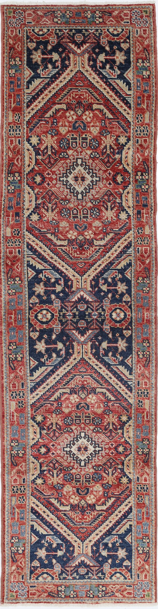 New Tribal Kazak hand-knotted wool rug 2'6" x 10'2" (76 x 310 cm) in red, from Artemis Rugs in Carmel, CA. Authentic handmade Kazak wool runner featuring bold tribal geometric patterns and traditional Caucasian designs. Crafted with high-quality, durable wool fibers using expert hand-knotting techniques. This vibrant red Kazak runner offers rich texture and genuine artisan craftsmanship, perfect for collectors and enthusiasts of authentic handmade tribal wool rugs