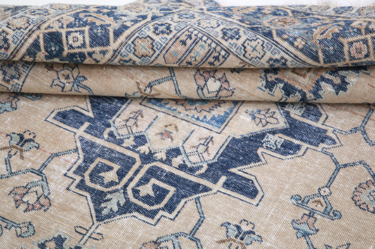 Vintage Distressed Heriz hand-knotted wool rug 4'5" x 6'3" (135 x 191 cm) in beige, from Artemis Rugs in Carmel, CA. Authentic vintage wool rug featuring traditional Heriz geometric patterns with a distressed, aged finish for a rustic look. Crafted using expert hand-knotting techniques and durable, high-quality wool fibers. This beige Heriz rug offers timeless style and artisanal craftsmanship, ideal for collectors and lovers of vintage tribal rugs with character