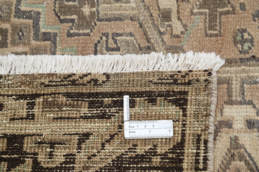 Vintage Heriz hand-knotted wool rug 9'4" x 12'8" (284 x 386 cm) in taupe, from Artemis Rugs in Carmel, CA. Authentic vintage wool rug featuring bold geometric patterns typical of Heriz designs. Crafted using traditional hand-knotting techniques with durable, high-quality wool fibers. This large taupe Heriz rug combines rustic charm with timeless craftsmanship, perfect for collectors and enthusiasts of vintage handmade tribal rugs